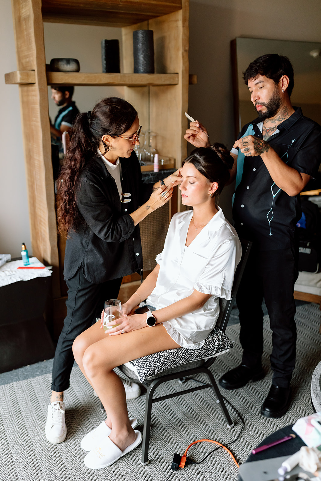 Styling Trio master artists working on a bride’s hair and makeup